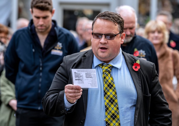 Cornwall councillor James Mustoe reads out the names of the fallen from Mevagissey. Picture: Paul Williams