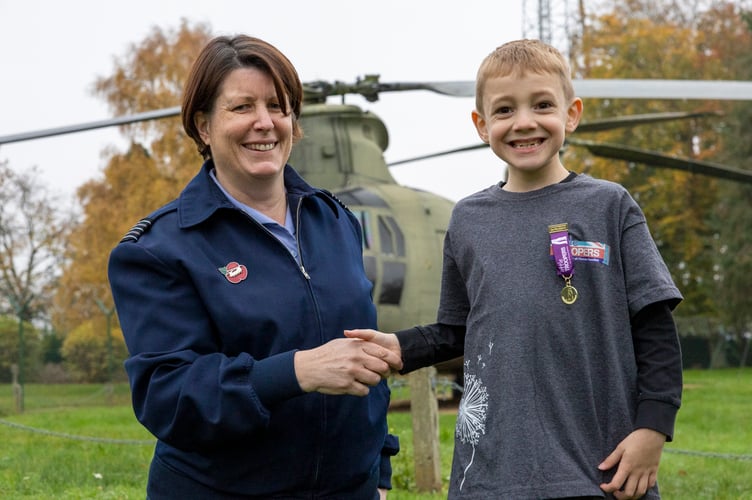 Wing Commander Jo Fields presents Teddy with the Little Troopers Award at RAF Odiham, November 2024.