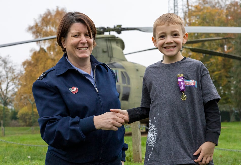 <p>Wing Commander Jo Field presents Teddy with his medal (Photo: Cpl Connor Tierney RAF)</p>