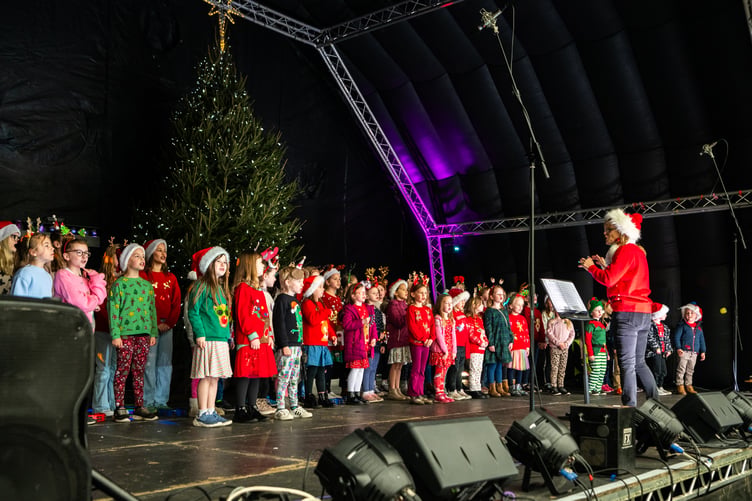 Youngsters get in the festive spirit by belting out some Christmas carols at the lights switch-on in Farnham