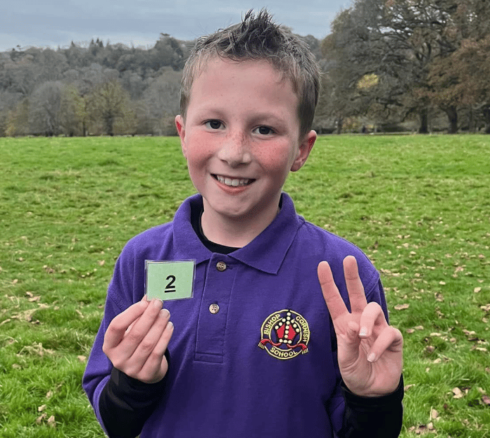 Bishop Cornish youngster Jacob Sweeney celebrates his second place finish in the Cross Country event at Lanhydrock
