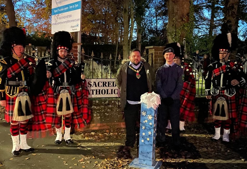 <p>Bordon mayor, Cllr James Fryer, prepares to turn on the town's Christmas lights in the company of the Sacred Heart Pipe Band.</p>