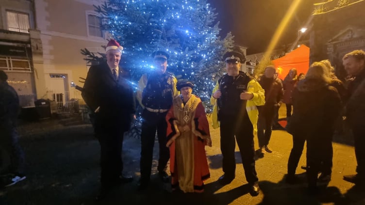 Liskeard Town Mayor Christina Whitty poses with local police and fellow Councillor, Simon Cassidy, by the town's Christmas tree