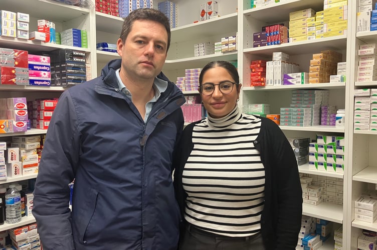 MP Chris Coghlan (left) visiting Asma'a (right) at her family-run pharmacy in Horley. 