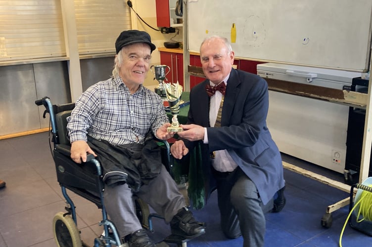 Simon Moran-Smith presents Greg Parker with first prize in the Thursday afternoon development group, Frensham Pond Sailability, December 4th 2024.