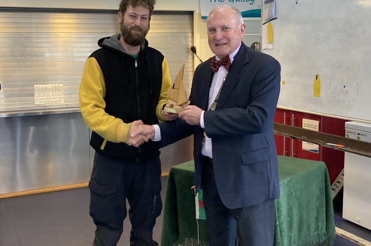 Simon Moran-Smith presents first prize in the Thursday afternoon racing group to Mike Everitt, Frensham Pond Sailability, December 4th 2024.