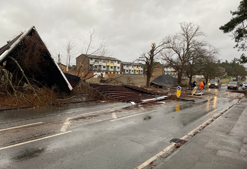 <p>A trail of debris was strewn across Camp Road in Bordon after gale force winds lifted the roof off an adjacent garage block.</p>