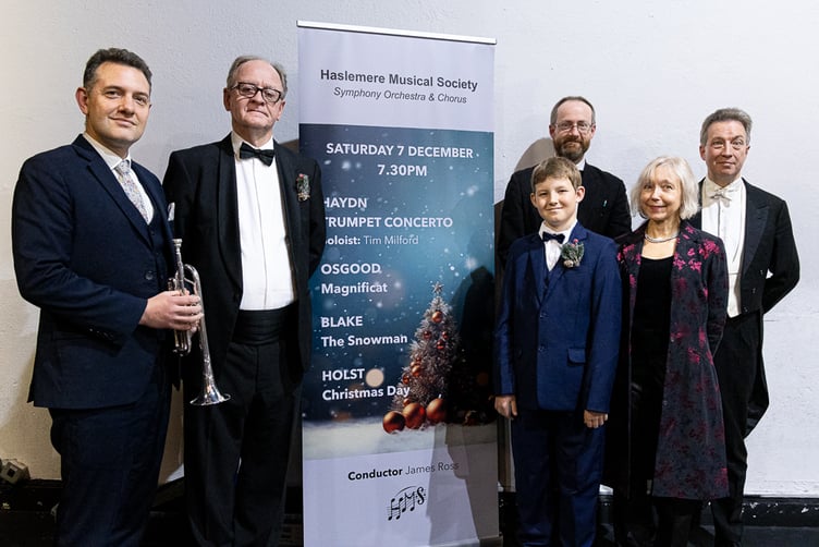 Haslemere Musical Society Christmas concert, Haslemere Hall, December 7th 2024. From left: Back - Tim Milford (trumpet), David Greenwood (narrator), Clive Osgood (composer) and James Ross (conductor). Front - Logan Broom (treble) and Clare Loosley (soprano soloist)