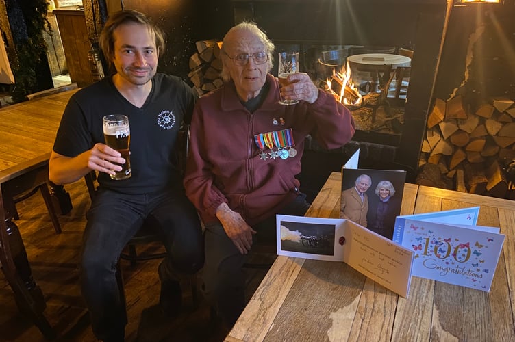 Carl Dadson, landlord of The Nelson Arms in Castle Street, Farnham, has a drink with his grandfather Ed Nelson to celebrate his 100th birthday on December 16th 2024.