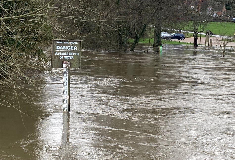 <p>The sign says it all - severe flooding in Tilford</p>