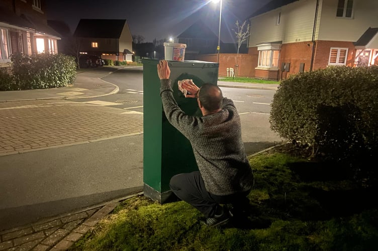 Cllr Chris Jackman cleaning up graffiti in Farnham.
