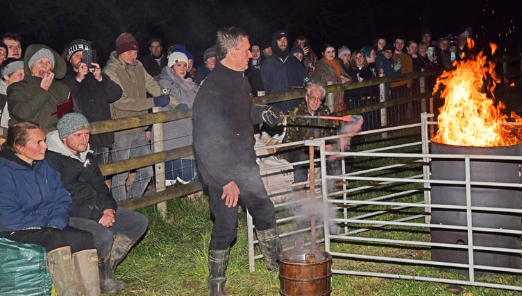 Cider boss David Sheppy works a bonfire to keep the crowds warm at this year's Sheppy's wassail. PHOTO: Alain Lockyer.