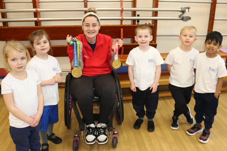 Kylie Grimes showing Highfield School kids her Gold medal from the Paralympics