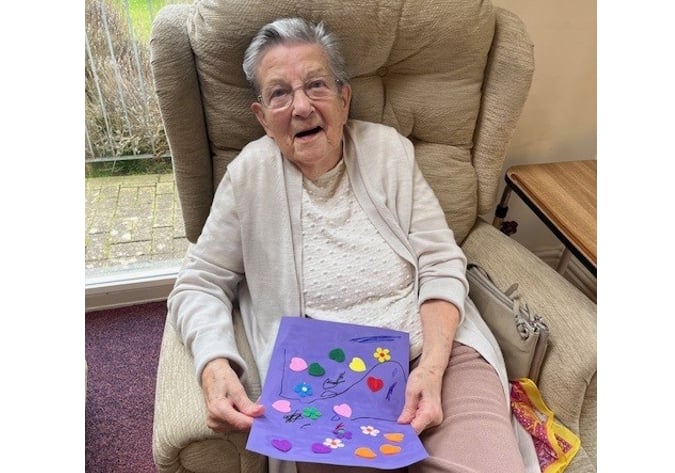 A Wentworth resident with one of the pictures that was created.