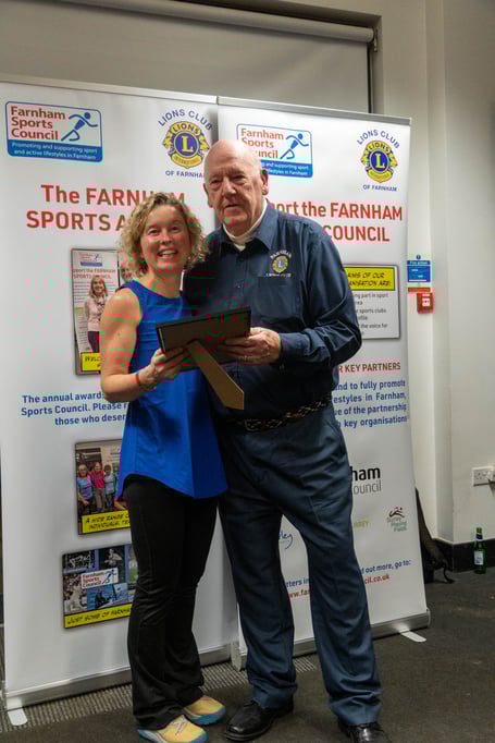 Optimise Foundation founder Leza Milligan receives a Farnham Sports Council award from Geoff Jeal of Farnham Lions (Photo: Paul Keogh/Farnham Sports Council)