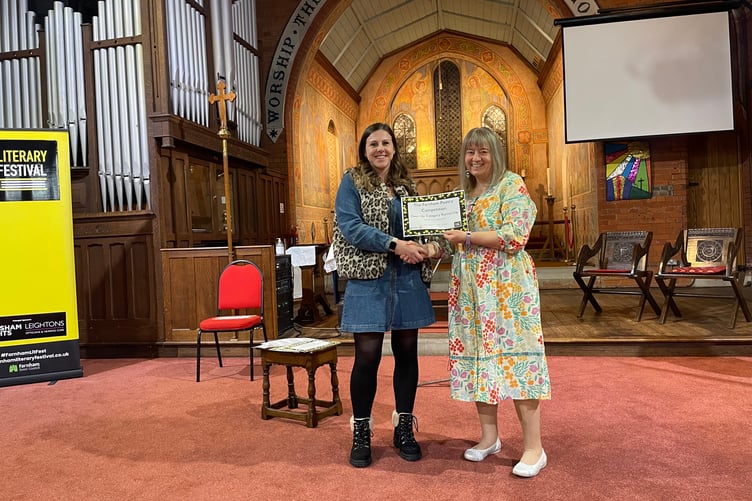 Poet Linda Daruvala presents Lucie Rhoades her Highly Commended prize for her poem 'Shared Disbelief'