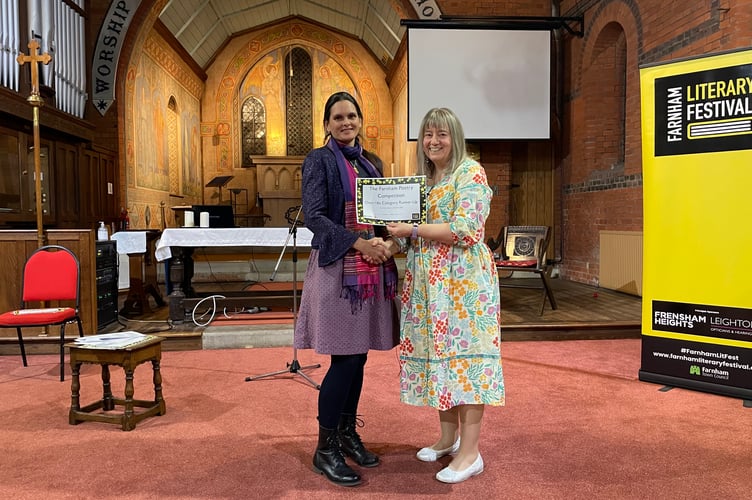 Poet Linda Daruvala presents Liz Kendall her Highly Commended award for her poem 'Forty Years On'.