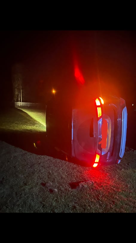 Car on its side on Tilford Green