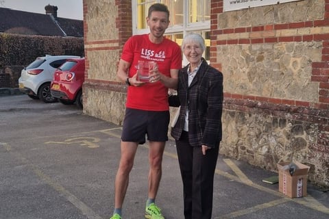 Men's champion Paul Stokoe receives his award from Margaret Stothard