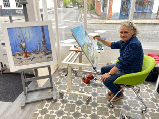 Coastal scene under creation by Tim Burns' paintbrush in Alton gallery