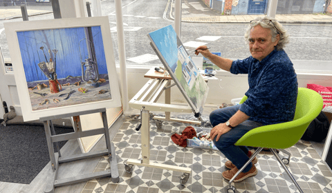 Coastal scene under creation by Tim Burns' paintbrush in Alton gallery