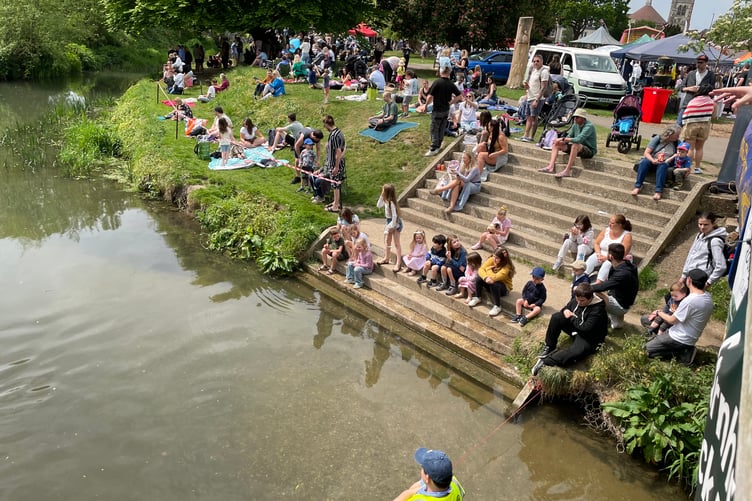 Crowds anticipate the ducks at the Great Farnham Duck Race 2025.