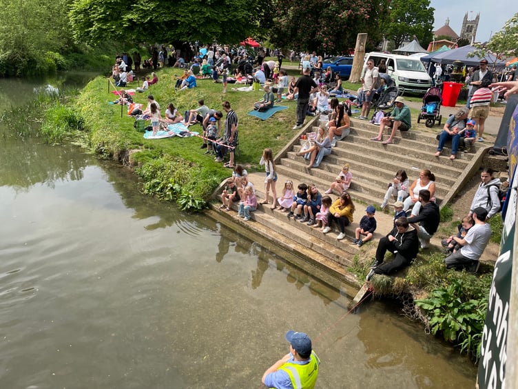 Crowds anticipate the ducks at the Great Farnham Duck Race 2025.
