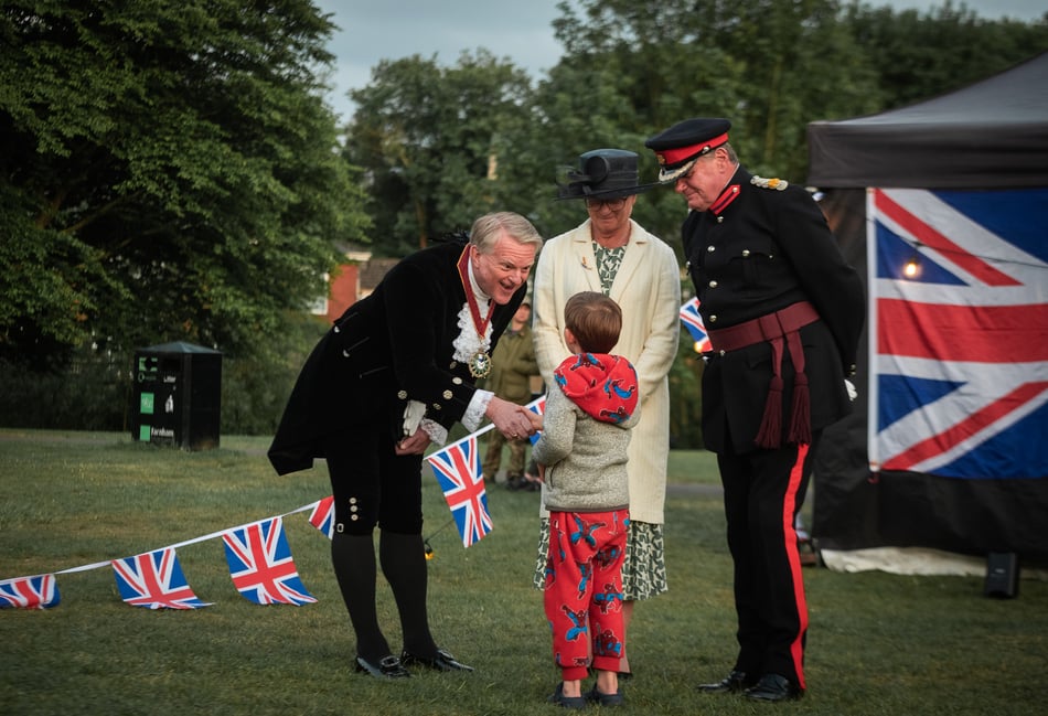 <p>A young lad meets dignitaries at VE Day 80 event in Farnham. (Natalia Sharomova/Farnham Town Council)</p>