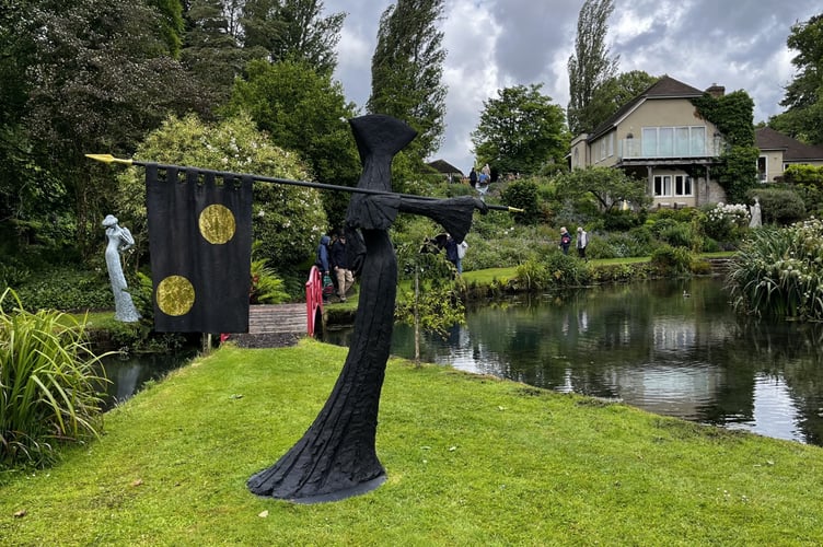 Guests explore the Jacksons’ sculpture-dotted garden during the Midhurst Palliative Care fundraiser