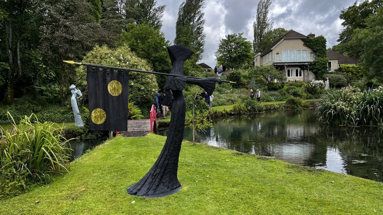 Guests explore the Jacksons’ sculpture-dotted garden during the Midhurst Palliative Care fundraiser