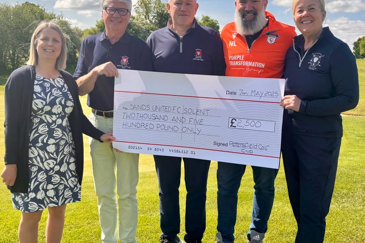 Nick Lang, second from right, receives a £2,500 cheque for Sands United FC Solent from Petersfield Golf Club's 2024 captains Stuart Garland, Simon Baigent and Heidi Oliver. The golf club's general manager Katie Laud is pictured far left. June 2025.