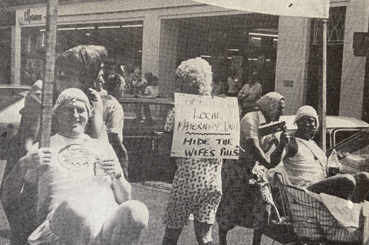 Haslemere Chamber of Trade and Commerce members dress up as babies and use shopping trolleys for prams, Princess Margaret Maternity Unit protest, Haslemere High Street, July 7th 1984.