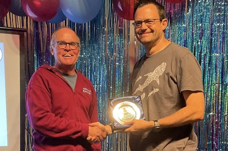 Justin Clarke presents Ivan Chunnett with the men's award for the most personal bests