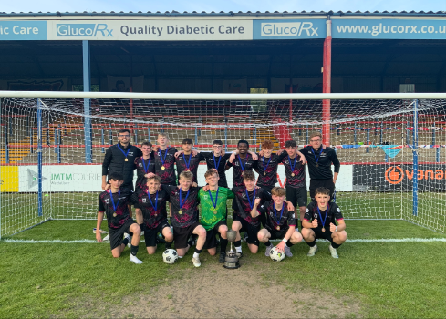 Oakmoor School's Year 10 Aldershot & Farnborough District Cup winners. From left: Back - Mr Gashi, Caden Oakley, Frankie Gregory, Daniel Haskell, Jake Dowker, Rishon Maxmilan, Harry Simms, Joshua Young and Mr Oliver. Front - Robbie Campbell, Ryan Warren, Benjamin Ayres, Sebastian Opara, Harry Travers, Garry Williams and Blake Hooper. EBB Stadium (Recreation Ground), Aldershot, May 2025.