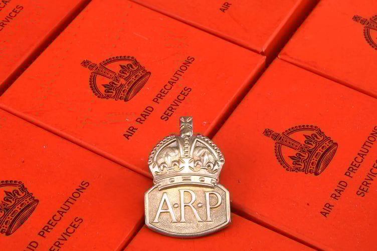 Boxes of original Air Raid Precautions badges.