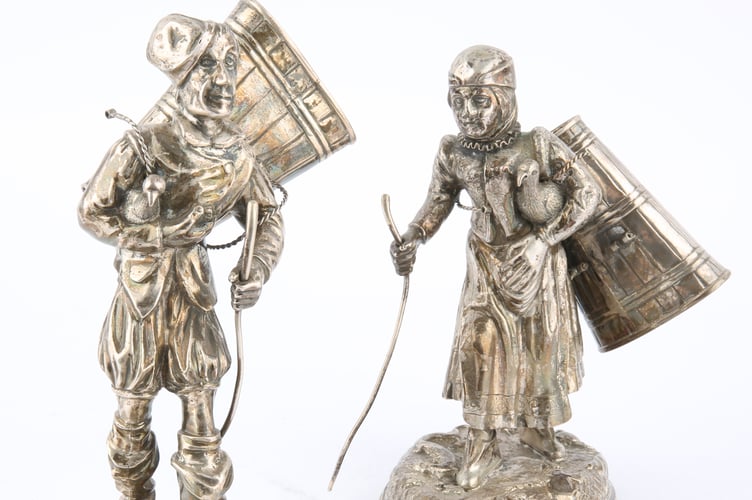 A pair of late 19th early 20th-century silver figures of grape pickers