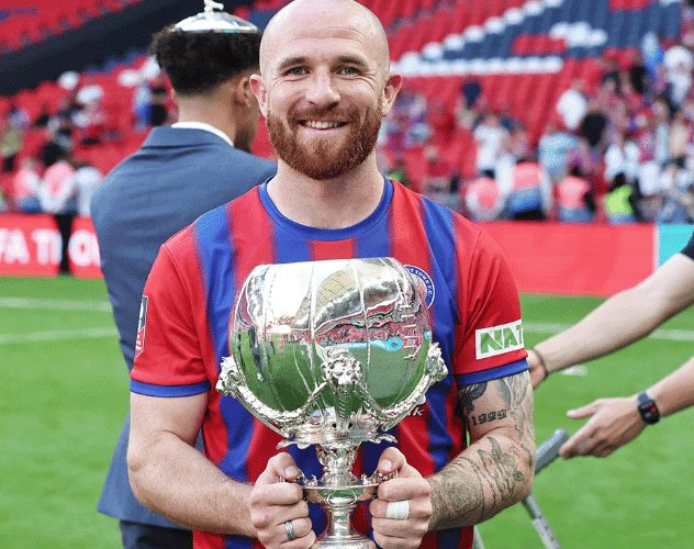 Theo Widdrington of Aldershot Town with the Isuzu FA Trophy at Wembley Stadium, May 11th 2025.