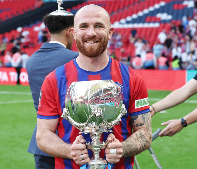 Theo Widdrington of Aldershot Town with the Isuzu FA Trophy at Wembley Stadium, May 11th 2025.