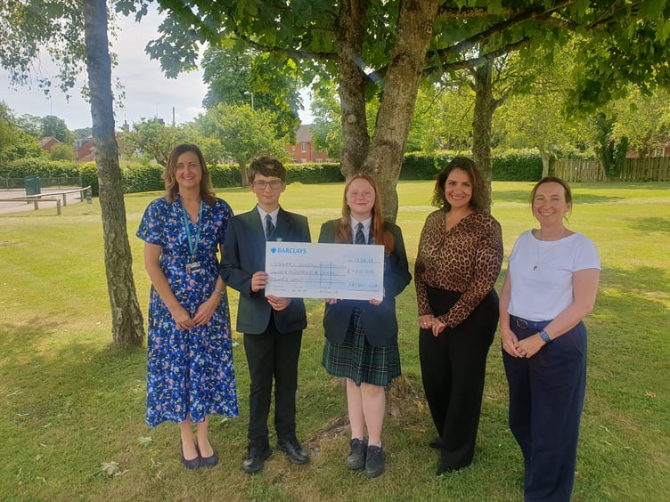Pupils receive a cheque for £750 from PelGar International, watched by Amina Kellie, Marion Goodes and Sarah Holman, Eggar's School, Holybourne, June 17th 2025.