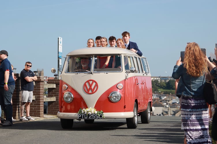 A group of students arrive in style for the prom.