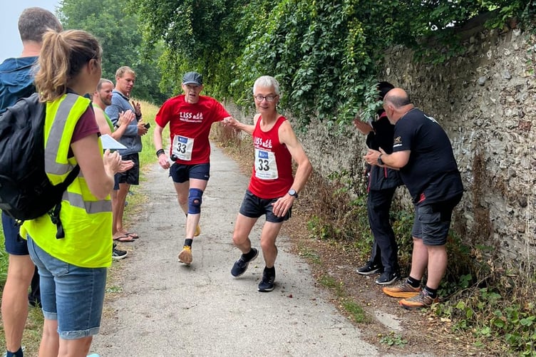 Aido Albury hands over to Dave Brown at the end of leg four to the east of Brighton