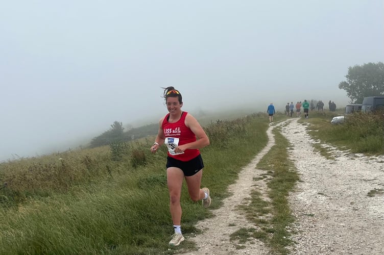 Rosie Watkins starts leg six at Ditchling Beacon with the sea fret still on the top of the Downs