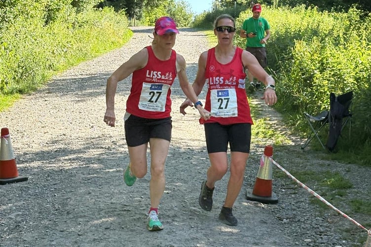 Alex Coomber takes the baton from Sandra Hunter at the start of leg 15 in Queen Elizabeth Country Park