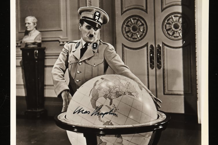 A signed photo of Charlie Chaplin in The Great Dictator.