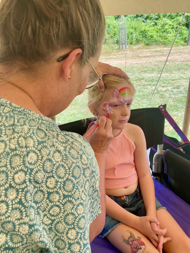 Elsie getting her face painted at Sky Rise Festival.