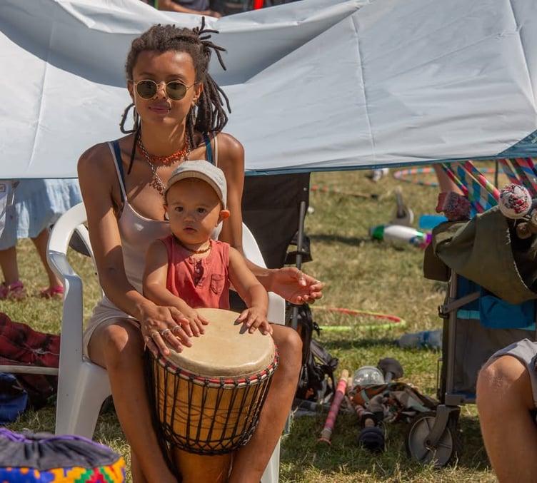 Festival goers banging on the drums.