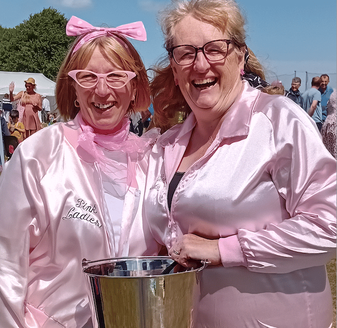 'Pink Ladies' Sue Mittelbach (left) and Wendy Jonas with the Fitzhead Fete golden raffle bucket.