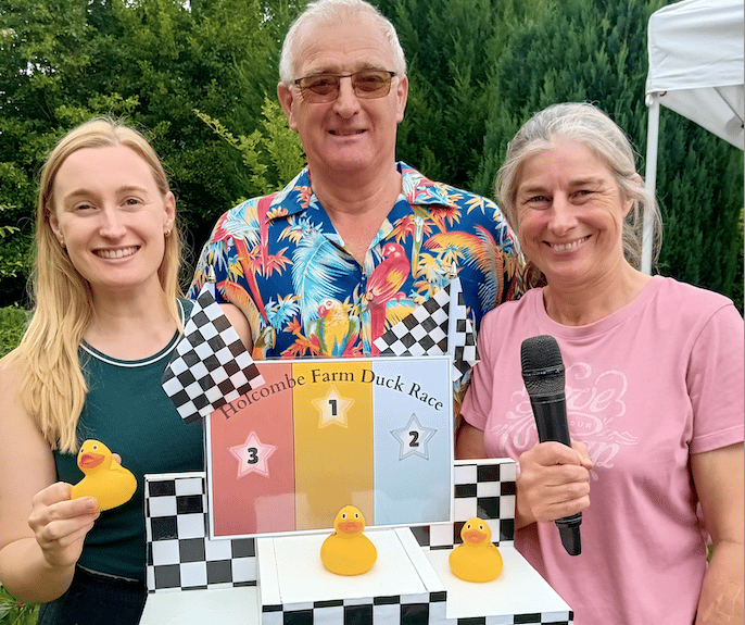 One of the three Fitzhead Fete duck race winners Becky Irish (left) with organiser Martin Irish and commentator Ros Death.
