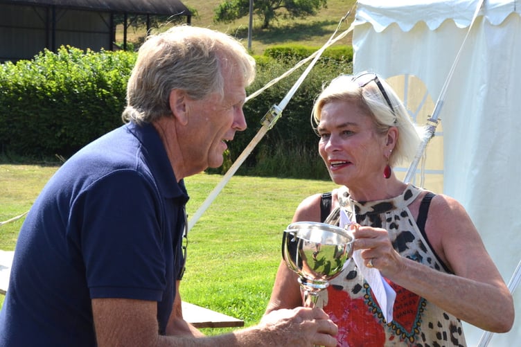 Chris Yates is presented by local MP Rachel Gilmour with one of the 10 trophies he won in Bicknoller Summer Flower Show.