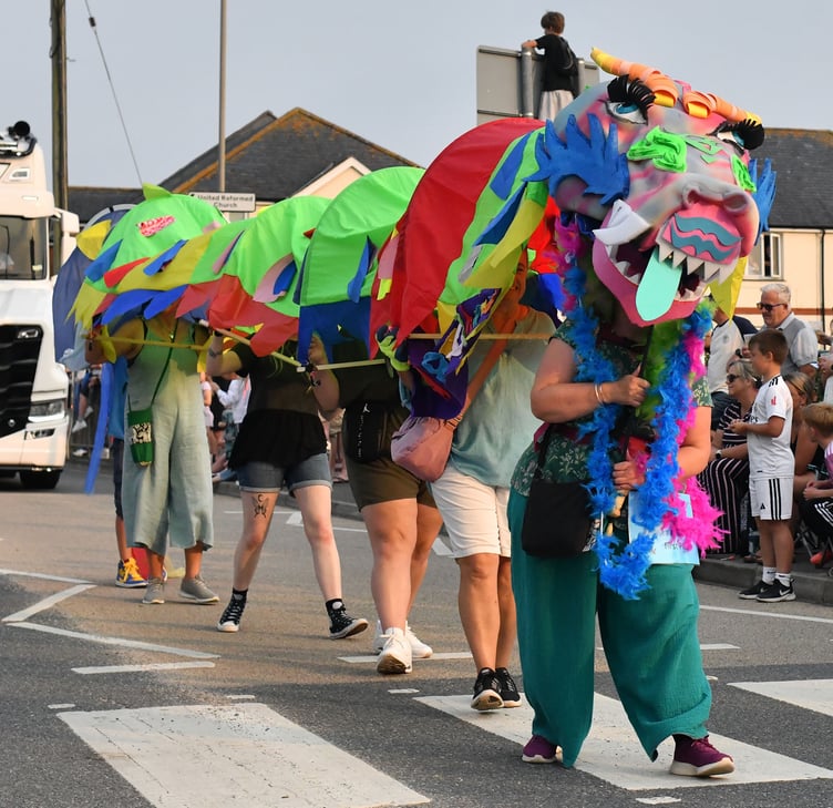 The Lower Wharf Lovelies make their way through the town with their colourful Dragon